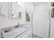 Bright bathroom featuring white cabinets, a marble countertop, and a shower with a white curtain at 19450 E Silver Creek Ln, Queen Creek, AZ 85142