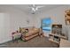 Comfortable bedroom with a trundle bed, ceiling fan, and plenty of natural light at 19450 E Silver Creek Ln, Queen Creek, AZ 85142