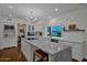 Modern kitchen featuring a marble island, white cabinets, stainless steel appliances, and wood floors at 19450 E Silver Creek Ln, Queen Creek, AZ 85142