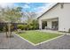 Beautifully landscaped backyard with lush green grass, outdoor seating, and a covered patio at 2022 N 22Nd Pl, Phoenix, AZ 85006