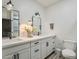 Modern bathroom featuring a double sink vanity, matte black hardware, and decorative mirror at 2022 N 22Nd Pl, Phoenix, AZ 85006