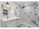 Updated bathroom featuring dual sinks, modern lighting, and a frameless glass shower at 2022 N 22Nd Pl, Phoenix, AZ 85006