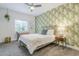 Stylish bedroom with fun wallpaper, ample natural light, and neutral carpet at 2022 N 22Nd Pl, Phoenix, AZ 85006