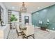 Open dining area with stylish light fixture, designer accent wall, and ample seating at 2022 N 22Nd Pl, Phoenix, AZ 85006