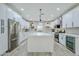 Bright kitchen with white cabinets, stainless steel appliances, and an oversized island at 2022 N 22Nd Pl, Phoenix, AZ 85006