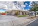 Exterior of home featuring a three car garage and desert landscaping at 21186 E Sunset Dr, Queen Creek, AZ 85142