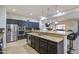 Kitchen features stainless steel appliances, granite counters and kitchen island with barstool seating at 21186 E Sunset Dr, Queen Creek, AZ 85142