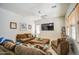 Inviting living room with comfortable couches and window with wood blinds at 21186 E Sunset Dr, Queen Creek, AZ 85142