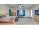 Serene main bedroom with comfortable furniture, ample natural light, and a ceiling fan at 21186 E Sunset Dr, Queen Creek, AZ 85142