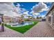 Backyard featuring a pool with a waterfall and lush landscaping at 21186 E Sunset Dr, Queen Creek, AZ 85142