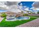 Backyard oasis features pool with rock waterfall and lush landscaping at 21186 E Sunset Dr, Queen Creek, AZ 85142