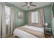 Serene bedroom with light green walls, ceiling fan, natural light, and neutral decor for a peaceful retreat at 21512 S 225Th Way, Queen Creek, AZ 85142