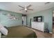 Main bedroom featuring overhead lighting, hardwood floors, and a television, creating a comfortable space at 21512 S 225Th Way, Queen Creek, AZ 85142