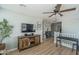 Upstairs bonus room featuring a ceiling fan, media center, and hardwood floors, providing ample entertainment space at 21512 S 225Th Way, Queen Creek, AZ 85142