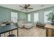 Living room featuring a neutral couch, table, ceiling fan, and natural light with plenty of space at 21512 S 225Th Way, Queen Creek, AZ 85142