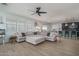 Spacious living room featuring a sectional sofa, tile flooring and lots of natural light at 21512 S 225Th Way, Queen Creek, AZ 85142