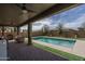 Relaxing pool featuring a covered patio, ceiling fan, beautiful sky, and green grass at 21512 S 225Th Way, Queen Creek, AZ 85142