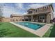 Backyard view featuring a large, inviting pool, patio, and well-maintained artificial turf for outdoor enjoyment at 21512 S 225Th Way, Queen Creek, AZ 85142