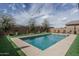 Sparkling pool with artificial turf and desert landscaping, perfect for cooling off on hot days at 21512 S 225Th Way, Queen Creek, AZ 85142