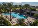 Relaxing community pool and covered lounge area with palm trees and plenty of seating, great for summer gatherings at 21512 S 225Th Way, Queen Creek, AZ 85142