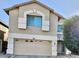 Two-story home featuring a two-car garage, stucco siding, and stylish architectural details at 2251 E Parkside Ln, Phoenix, AZ 85024