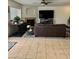 Spacious living room featuring tile flooring, a ceiling fan, and cozy fireplace at 2251 E Parkside Ln, Phoenix, AZ 85024