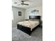 Bright primary bedroom featuring a black bed frame, two side tables, and a ceiling fan at 2251 E Parkside Ln, Phoenix, AZ 85024