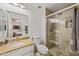 Tiled bathroom featuring a glass shower, granite countertop vanity, and mirrored cabinet at 2315 W Union Hills Dr # 119, Phoenix, AZ 85027