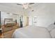 Bright bedroom featuring a large mirrored closet, hardwood flooring, and ceiling fan at 2315 W Union Hills Dr # 119, Phoenix, AZ 85027