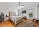 Bright bedroom featuring a ceiling fan, door to balcony, and hardwood flooring at 2315 W Union Hills Dr # 119, Phoenix, AZ 85027