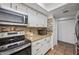 View of the kitchen featuring stainless steel appliances, granite countertops, and white cabinets at 2315 W Union Hills Dr # 119, Phoenix, AZ 85027