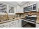 Another angle of the updated kitchen with stainless steel appliances and granite countertops at 2315 W Union Hills Dr # 119, Phoenix, AZ 85027