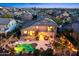 Dusk aerial view of a beautiful property featuring a pool and patio with string lights at 2678 E Firestone Dr, Chandler, AZ 85249