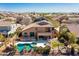 Aerial view of the backyard and pool featuring a large rock waterfall and lush landscaping at 2678 E Firestone Dr, Chandler, AZ 85249