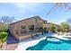 Exterior view of home featuring a pool, patio, deck, and lush landscaping creating an outdoor living space at 2678 E Firestone Dr, Chandler, AZ 85249