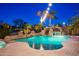 Backyard pool featuring a rock waterfall, a waterslide, and lush tropical landscaping at 2678 E Firestone Dr, Chandler, AZ 85249