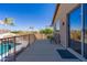 Balcony boasts views of the pool and lush backyard landscaping, with chairs for enjoying the scenery at 2678 E Firestone Dr, Chandler, AZ 85249