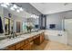 Bathroom features dual sinks with granite countertops, white cabinets, large mirror, bathtub, and glass-enclosed shower at 2678 E Firestone Dr, Chandler, AZ 85249