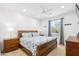 Bright bedroom with a wooden bed frame, blue patterned comforter, and a ceiling fan at 2678 E Firestone Dr, Chandler, AZ 85249