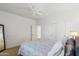 Bright bedroom with a ceiling fan, a door to an adjacent room, a mirrored wall feature, and a full-sized bed at 2678 E Firestone Dr, Chandler, AZ 85249