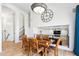 Open dining area with a modern chandelier, wooden table, and easy access to the staircase at 2678 E Firestone Dr, Chandler, AZ 85249