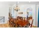 Formal dining room with a large table, chandelier, and access to the staircase at 2678 E Firestone Dr, Chandler, AZ 85249