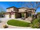 Inviting two-story home featuring a well-manicured lawn, desert landscaping and stone accents at 2678 E Firestone Dr, Chandler, AZ 85249