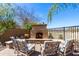 Cozy outdoor fireplace and seating area, perfect for relaxing and entertaining in this landscaped backyard at 2678 E Firestone Dr, Chandler, AZ 85249