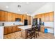 Spacious kitchen featuring a center island, stainless steel appliances, white countertops, and wood cabinets at 2678 E Firestone Dr, Chandler, AZ 85249