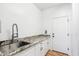 Laundry room featuring granite countertops, a stainless steel sink and faucet, and white cabinets at 2678 E Firestone Dr, Chandler, AZ 85249