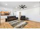 Bright and spacious living room with wood floors, a comfortable leather sofa, and an open layout at 2678 E Firestone Dr, Chandler, AZ 85249