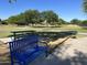 A neighborhood park with green space featuring a picnic table and park bench on a sunny day at 2678 E Firestone Dr, Chandler, AZ 85249