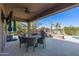 Covered patio with outdoor dining area and grill, perfect for entertaining, plus view of pool and landscaping at 2678 E Firestone Dr, Chandler, AZ 85249