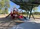 Community playground with slides, climbing equipment, and seating areas under a shade structure at 2678 E Firestone Dr, Chandler, AZ 85249